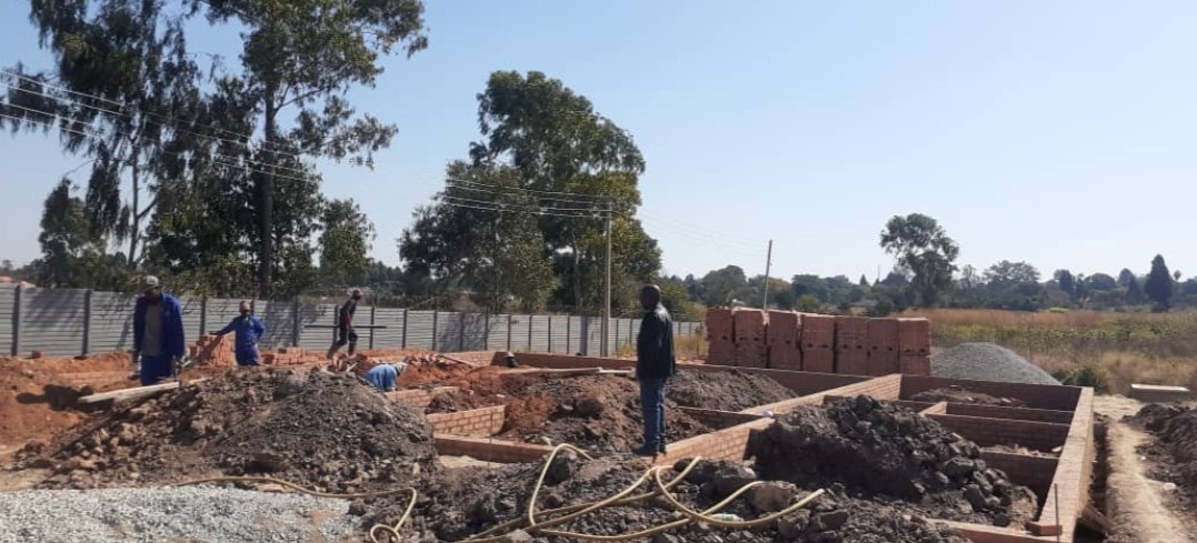 African Man standing in middle of Construction works