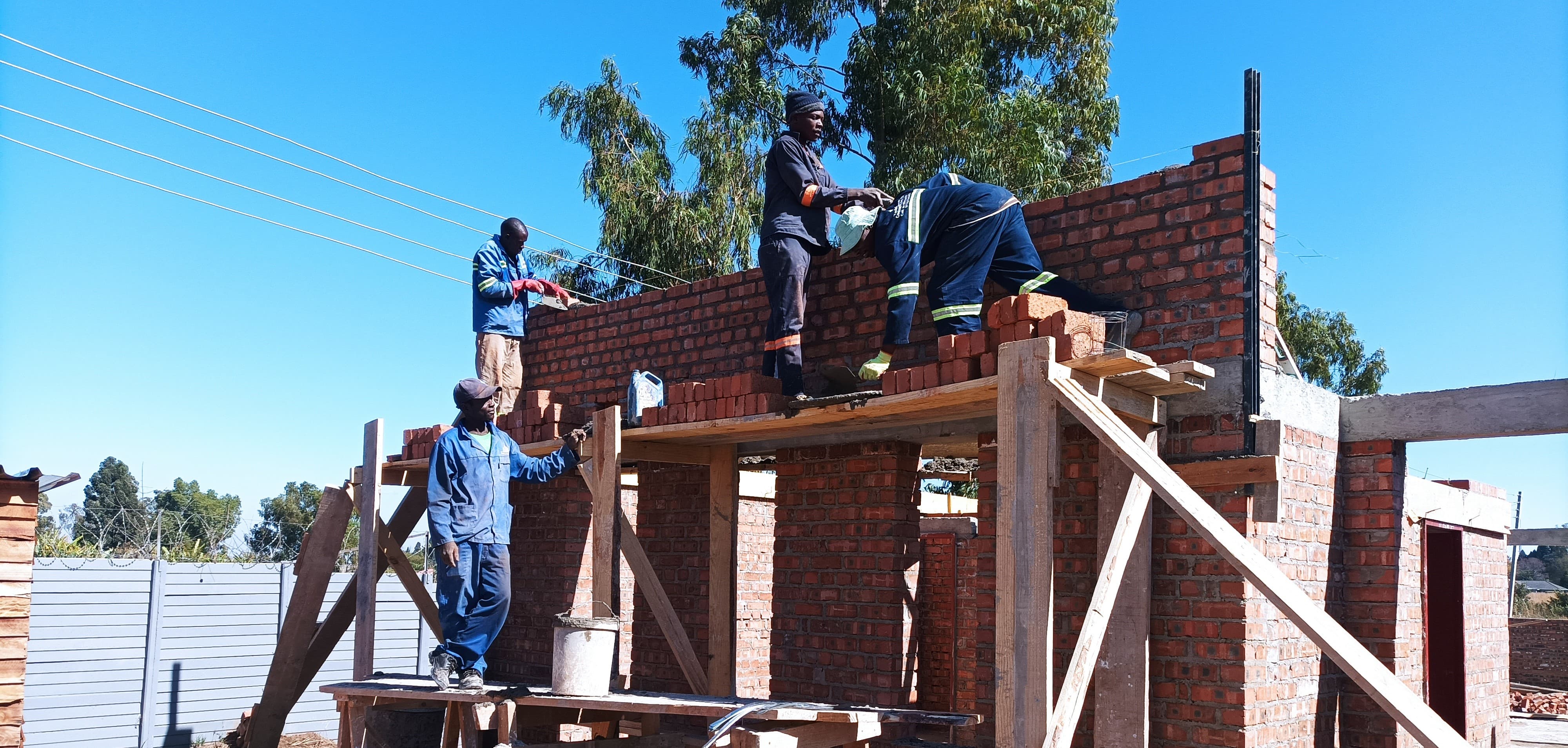 Men Working on A Building with Scaffold